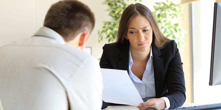 Woman staring at a resume that looks questionable