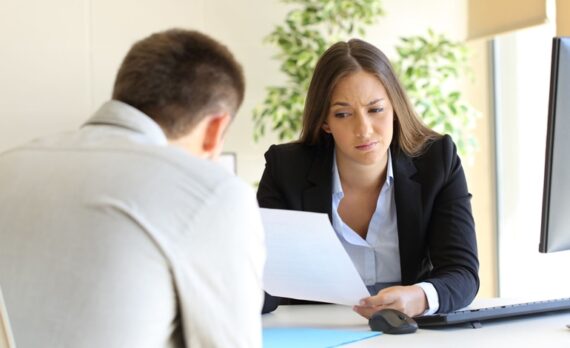 Woman staring at a resume that looks questionable