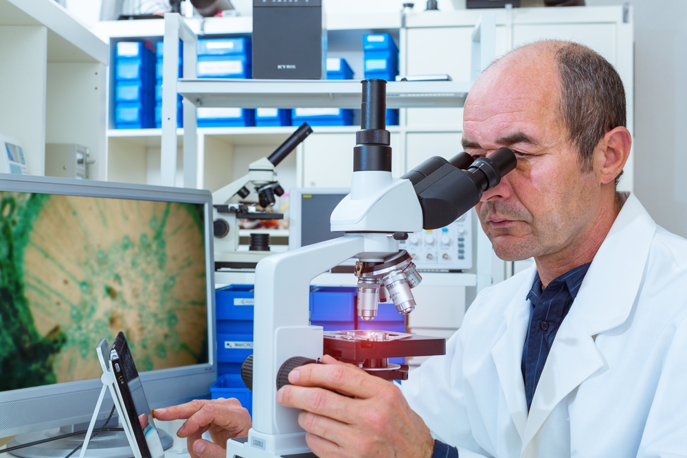 Scientist looking into a microscope